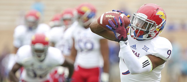 Kansas safety Fish Smithson catches a pass during warmups prior to the Jayhawks' kickoff against Duke on Saturday, Sept. 13, 2014, at Wallace Wade Stadium in Durham, North Carolina.