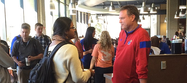 Kansas University basketball coach Bill Self talks with a student Thursday afternoon on campus. Self and his staff stopped by the Underground at Wescoe to buy lunch.