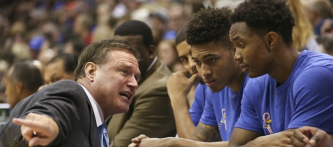 Kansas head coach Bill Self takes a knee to talk with some of the freshman during the second half on Tuesday, Nov. 11, 2014.