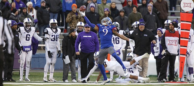 Kansas receiver Nigel King tips a deep pass to himself to keep it in bounds for an eventual touchdown against TCU during the third quarter on Saturday, Nov. 15, 2014 at Memorial Stadium.