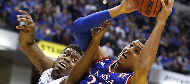 Kansas forward Landen Lucas (33) grabs a rebound from Kentucky center Dakari Johnson (44) during the first half of the Champions Classic on Tuesday, Nov. 18, 2014 at Bankers Life Fieldhouse in Indianapolis.