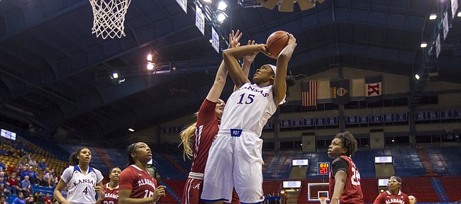 Kansas senior forward Chelsea Gardner (15) scores two of her game high 30 points over Alabama junior forward Nikki Hegstetter during the first game of the 2014 Naismith Hall of Fame Women's Challenge Friday evening at Allen Fieldhouse. Despite Gardner's 30 points, the Jayhawks were unable to hold off the Crimson Tide, falling 85-80. The Jayhawks will take the court again tomorrow for game two of the challenge against Temple. Tip off is set for 4 p.m. at Allen Fieldhouse.