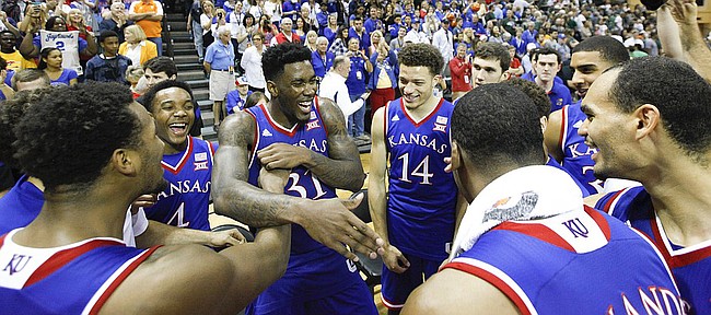 Kansas forward Jamari Traylor (31) is surrounded by his teammates after the Jayhawks' win over Michigan State  during the championship of the Orlando Classic on Sunday, Nov. 30, 2014 at the HP Field House in Kissimmee, Florida.