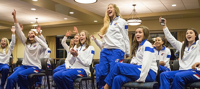 Kansas senior Chelsea Albers leaps out of her chair as she and the rest of her teammates learn their fate after being selected to play in the 2014 NCAA tournament Sunday evening inside Allen Fieldhouse. The Jayhawks earned the 16th overall seed and will face the University of Arkansas-Little Rock in the first round. 