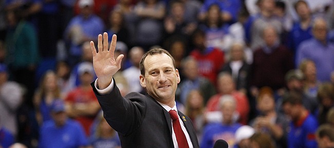 Newly-hired Kansas head football coach David Beaty waves to the crowd as he is introduced to the Allen Fieldhouse crowd during halftime of the JayhawksÕ game against Floriday on Friday, Dec. 5, 2014. Beaty is the 38th head coach in the programÕs history.