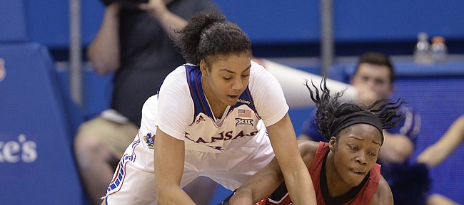 Forward Jada Brown dives to the ground with Amanda Lawson of Arkansas State to try and gain possession of a loose ball in the second half Sunday at Allen Fieldhouse.