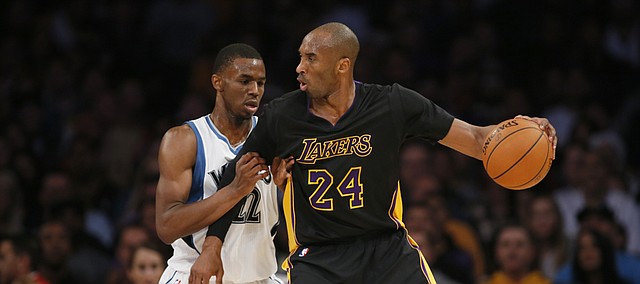 Minnesota Timberwolves' Andrew Wiggins defends against Los Angeles Lakers' Kobe Bryant during the first half of an NBA basketball game Friday, Nov. 28, 2014, in Los Angeles
