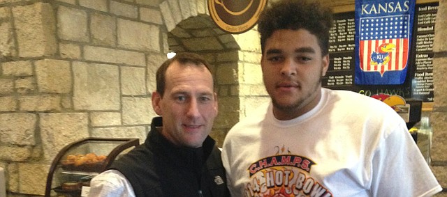 Former Trinitiy Valley Community College offensive lineman and new Jayhawk D'Andre Banks, right, took time during his recent campus visit to pose for a photograph with new Kansas University football coach David Beaty. Banks was one of eight junior-college players to sign letters of intent with the Jayhawks on Wednesday, Dec. 17, 2014, the first day of the mid-year transfer signing period. 