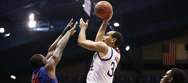 Kansas forward Perry Ellis (34) turns for a shot over Florida forward Dorian Finney-Smith (10) during the second half on Friday, Dec. 5, 2014 at Allen Fieldhouse.