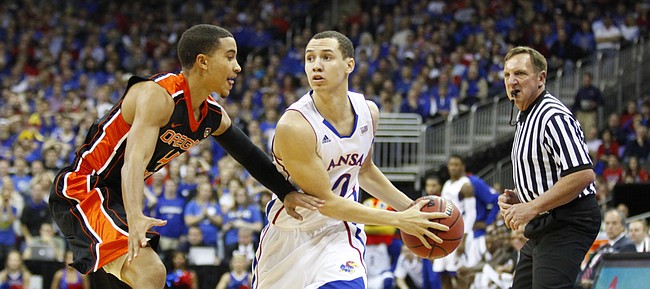 Kansas guard Evan Manning looks to pass inside against Oregon State guard Challe Barton during the first half on Friday, Nov. 30, 2012 at the Sprint Center in Kansas City, Missouri.