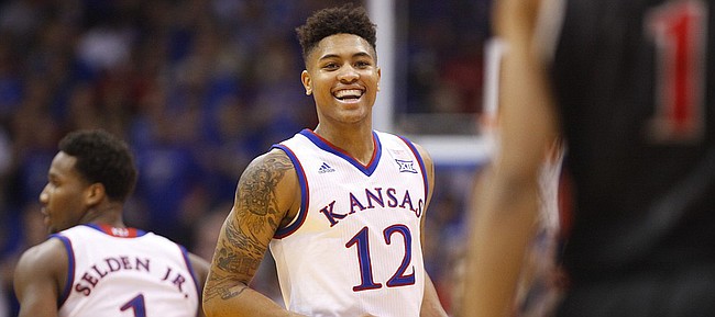 Kansas guard Kelly Oubre Jr. (12) smiles at UNLV guard Rashad Vaughn (1) after a bucket during the first half on Sunday, Jan. 4, 2015 at Allen Fieldhouse.