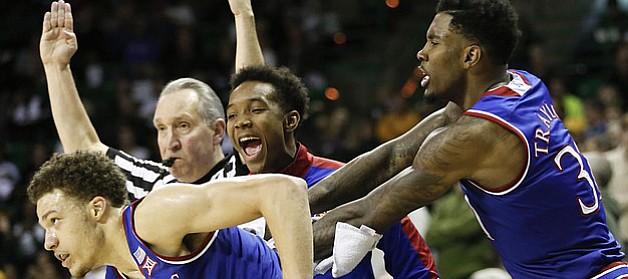 Kansas guard Brannen Greene (14) gets a celebratory shove from teammate Jamari Traylor, right, after hitting a three-pointer against Baylor with time dwindling in regulation on Wednesday, Jan. 7, 2014 at Ferrell Center in Waco, Texas. Also pictured is injured guard Devonte Graham.