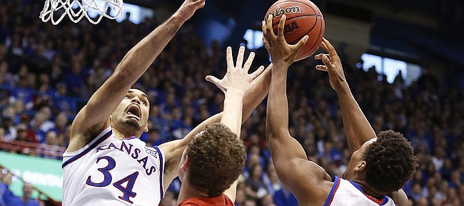 Kansas forward Perry Ellis (34) and guard Wayne Selden Jr. (1) fight for a rebound with Texas Tech guard Robert Turner (14) during the second half on Saturday, Jan.10, 2015 at Allen Fieldhouse.