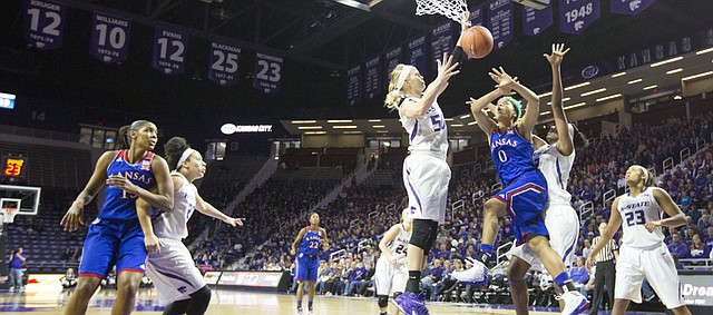 Kansas senior guard Asia Boyd (0) loses the ball under the basket while being double teamed by Kansas State's Shaelyn Martin (50) and Breanna Lewis (22)  during the second half of their game Sunday afternoon at Bramlage Coliseum in Manhattan. Despite a quick start by the Jayhawks that saw them surge to a 14 point lead, Kansas fell to the Wildcats, 58-52, and dropped to 0-3 in Big 12 play.