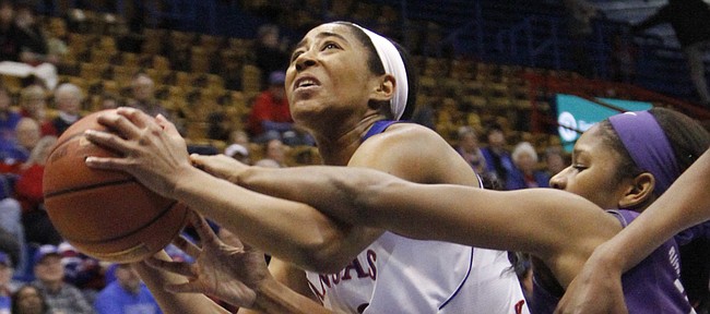 KU's guard Natalie Knight (42) fights off TCU's Jada Butts (15) as Knight goes up for two points.