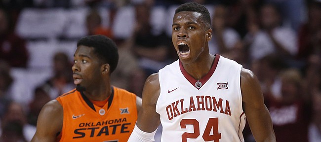 Oklahoma guard Buddy Hield (24) celebrates a basket in front of Oklahoma State guard Tavarius Shine (5) during the first half Saturday, Jan. 17, 2015, in Norman, Oklahoma. Hield, who in the offseason predicted the Sooners would win the Big 12, will lead OU against Kansas in a Big Monday meeting Monday in Allen Fieldhouse.