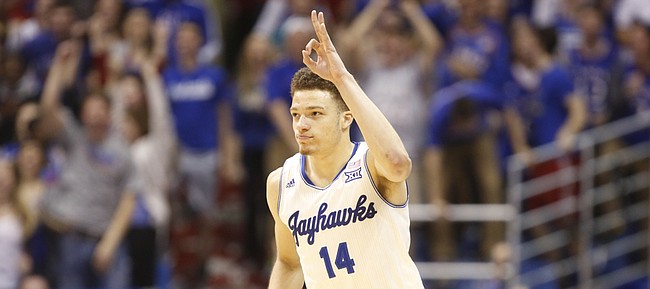 Kansas guard Brannen Greene throws up three fingers after sinking a three against Oklahoma to reclaim the lead late in the second half on Monday, Jan. 19, 2015 at Allen Fieldhouse.