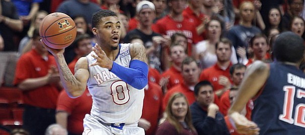 Kansas guard Frank Mason III, (0) saves a loose ball from going out of bounds during the first half on Tuesday, Feb. 10, 2015 at United Supermarkets Arena.
