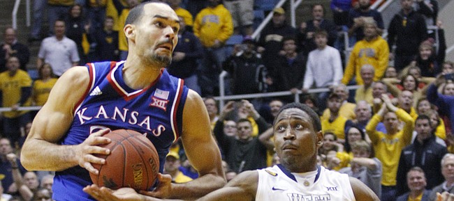 Kansas forward Perry Ellis (34) is defended by West Virginia guard Juwan Staten (3) after Ellis caught a long pass from Jamari Traylor in an attempt for a last-second shot at the end of the Jayhawks 62-61 loss game against the West Virginia Mountaineers Monday, February 16, 2105  in Morgantown, W.V.