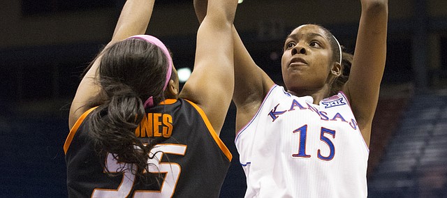 Kansas senior forward Chelsea Gardner (15) shoots over Oklahoma State defender Lashawn Jones (55) during the annual Jayhawks for a Cure game Saturday evening at Allen Fieldhouse.