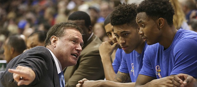 Kansas head coach Bill Self takes a knee to talk with some of the freshman during the second half on Tuesday, Nov. 11, 2014.