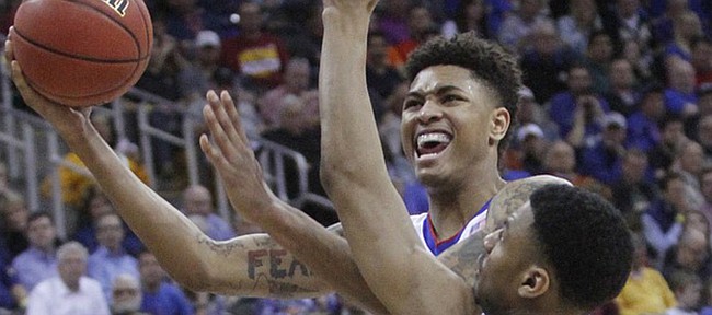 Kansas guard Kelly Oubre III (12) goes up strong for two points against TCU's Karviar Shepard (14) during the Jayhawk’s 64-59 win over TCU Thursday at the Sprint Center in Kansas City, MO. 