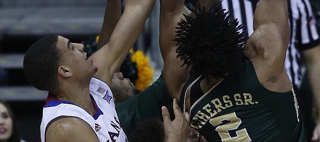 Kansas forward Landen Lucas (33) attempts a block on Baylor's Rico Gathers (2) in the Jayhawk’s 62-52 win over Baylor in the semi-final of the Big 12 Tournament. 
