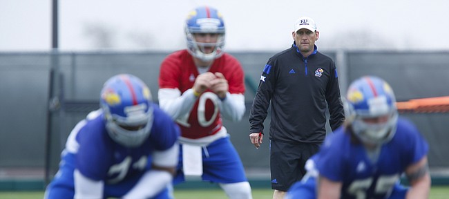 Kansas head football coach David Beaty watches a snap during spring practice on Tuesday, March 24, 2015.