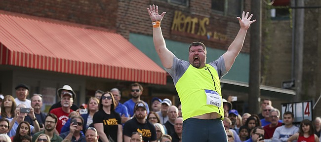 Competitor Christian Cantwell throws his arms in the air with a roar as he watches his final throw of the the night during the Downtown Olympic Shot Put event on Friday, April 17, 2015 at the intersection of Eighth and New Hampshire streets. Cantwell won the competion with a throw of 70 feet six and one-half inches.