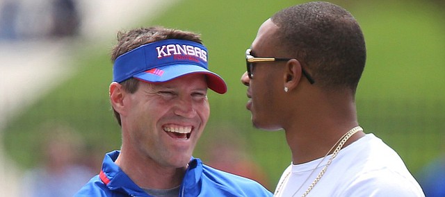 Kansas defensive coordinator Clint Bowen laughs with former player Bradley McDougald during the Spring Game on Saturday, April 25, 2015 at Memorial Stadium.