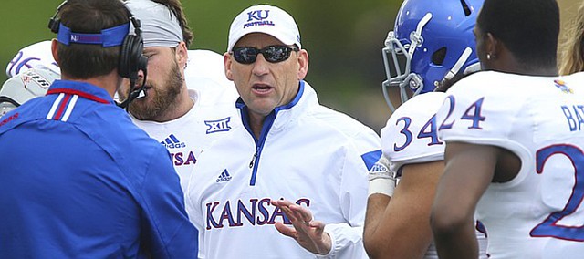 Kansas head coach David Beaty talks with his players after starting quarterback Michael Cummings left the game with an injury during the Spring Game on Saturday, April 25, 2015 at Memorial Stadium.
