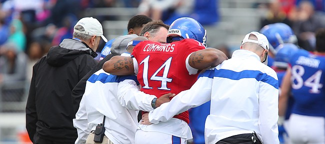 Blue Team starting quarterback Michael Cummings his helped off of the field by trainers during the Spring Game on Saturday, April 25, 2015 at Memorial Stadium.