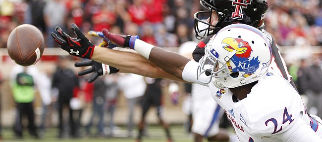 Kansas cornerback JaCorey Shepherd knocks away a pass intended for Texas Tech receiver Dylan Cantrell during the first quarter on Saturday, Oct. 18, 2014 at Jones AT&T Stadium in Lubbock, Texas.