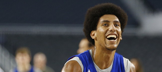 Kansas forward Kevin Young smiles as he and his teammates shoot around during a day of practices and press conference for teams in the South Regional at Cowboys Stadium in Arlington, Texas on Thursday, March 28, 2013.