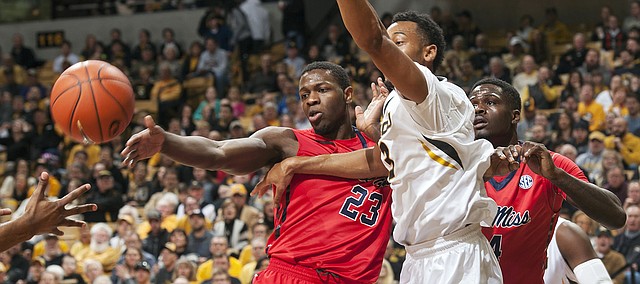 Missouri's Johnathan Williams III, center, battles Mississippi's Dwight Coleby, left, and Mississippi's M.J. Rhett, right, for a rebound during the first half of an NCAA college basketball game Saturday, Jan. 31, 2015, in Columbia, Mo. (AP Photo/L.G. Patterson)

