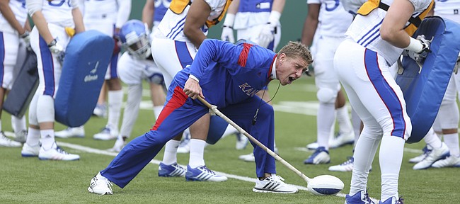 Kansas special teams and tight ends coach Gary Hyman gives a count as he works with the special teams unit during practice on Monday, April 7, 2015.