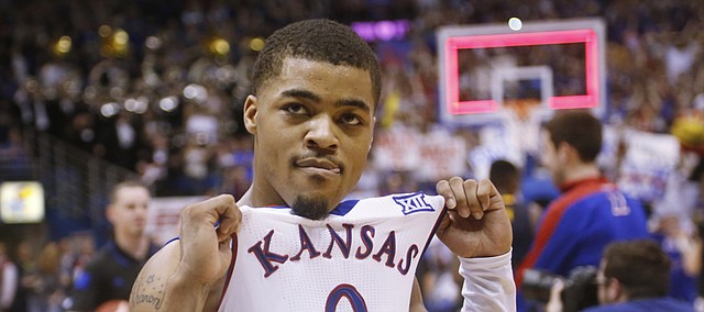 Kansas guard Frank Mason III (0) lifts his jersey to the crowd at the end of overtime and Jayhawks' 76-69 win over the West Virginia Mountaineers on Tuesday, March 4, 2015 at Allen Fieldhouse.