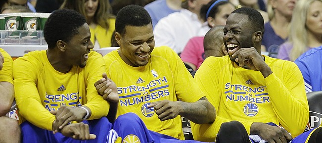 Golden State Warriors players laugh on the bench in the second half of Game 6 of a second-round NBA basketball Western Conference playoff series against the Memphis Grizzlies Friday, May 15, 2015, in Memphis, Tenn. The Warriors won 108-95 to win the series 4-2. From left are Justin Holiday, Brandon Rush, Draymond Green, and Stephen Curry. (AP Photo/Mark Humphrey)