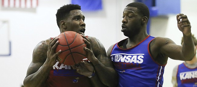 Red Team player Jamari Traylor heads to the bucket against Blue Team player Elijah Johnson during a scrimmage, Wednesday, June 10, 2015 at the Horejsi Family Athletic Center.
