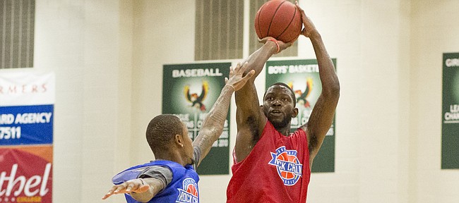 Red team's Mario Little shoots over defender Ben McLemore during the annual Rock Chalk Roundball Classic basketball game Thursday evening at Free State High School. Proceeds from the game, which features former Kansas University players, benefits families fighting cancer. This year's beneficiaries were Levi Ross and Dade Cannon.