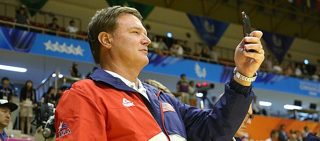 Kansas coach Bill Self records the Team USA players during the medal ceremony after their double-overtime win against Germany Monday, July 13, at the World University Games in South Korea.
