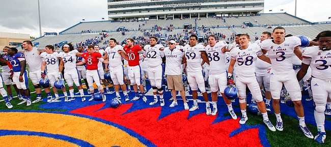 Head coach David Beaty and the Kansas University football team close their spring game by singing the KU Alma Mater. Beaty inherits a squad woefully short of numbers and one that is looking for walk-ons to fill the gaps.