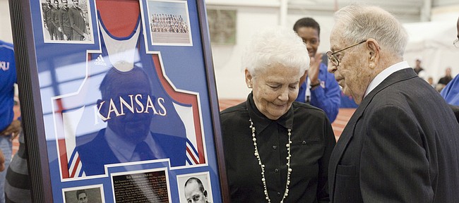 Former Kansas track coach Bob Timmons, right, with his wife, Pat, is recognized Friday, Dec. 2, 2011 during the Bob Timmons Challenge at Anschutz Sports Pavilion. Timmons will be inducted into the USA Track and Field Hall of Fame in St. Louis on Saturday.