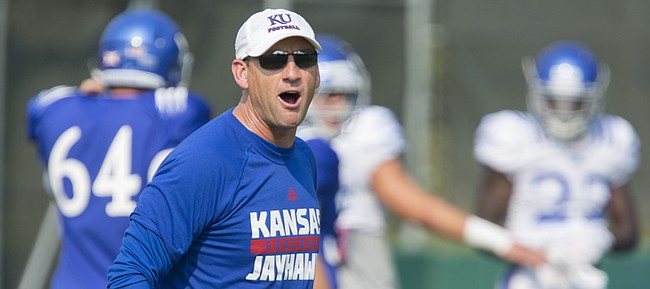 Kansas University football coach David Beaty gives a directive to his players from across the field during practice on Wednesday, Aug. 26, 2015.