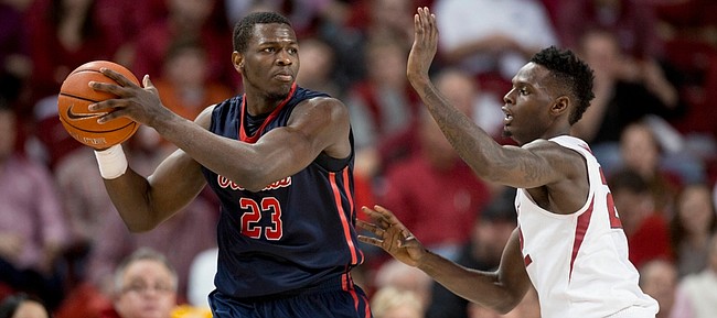Mississippi center Dwight Coleby, left, looks to pass as he's defended by Arkansas forward Jacorey Williams in this photo from Jan. 17 in Fayetteville, Arkansas.