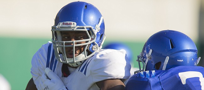 Kansas defensive end Damani Mosby tries to make his way around a blocker during practice, Thursday, Aug. 20, 2015.