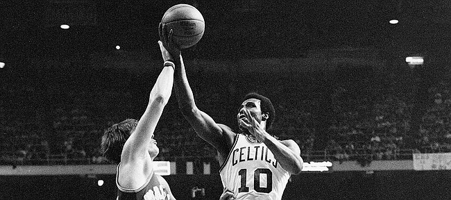 Boston Celtics' Jo Jo White lays up a shot over Golden State Warriors' Rick Barry, in their National Basketball Association game at the Boston Garden, Feb. 29, 1976. Boston won the game 119 to 101. (AP Photo/J. Walter Green)
