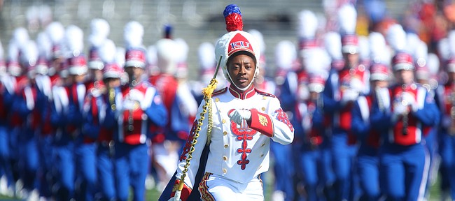 A drum major leads the Kansas University marching band onto the field prior to kickoff on Saturday, Sept. 5, 2015 at Memorial Stadium.