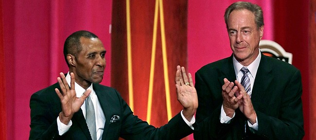 Basketball Hall of Fame inductee Jo Jo White, left, pauses to acknowledge applause during the enshrinement ceremony for the Class of 2015 of the Naismith Memorial Basketball Hall of Fame on Friday in Springfield, Massachusetts. At right is White’s Boston Celtics teammate, Hall of Famer Dave Cowens.