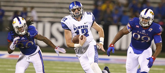 Memphis quarterback Paxton Lynch (12) escapes Kansas defenders Tevin Shaw (30) and Corey King (99) during the third quarter on Saturday, Sept. 12, 2015 at Memorial Stadium.